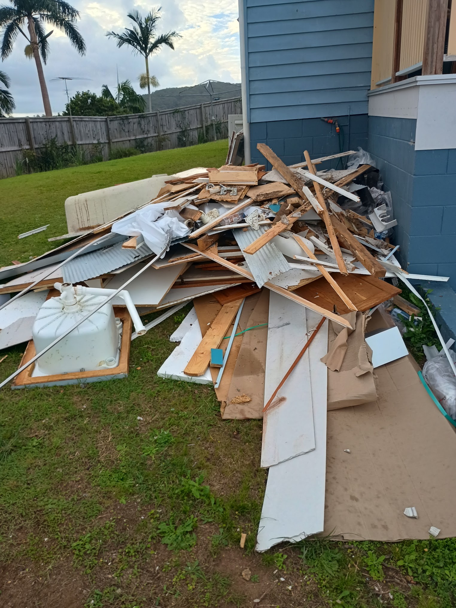 Renovation and strip-out debris piled for removal beside a Sunshine Coast home
