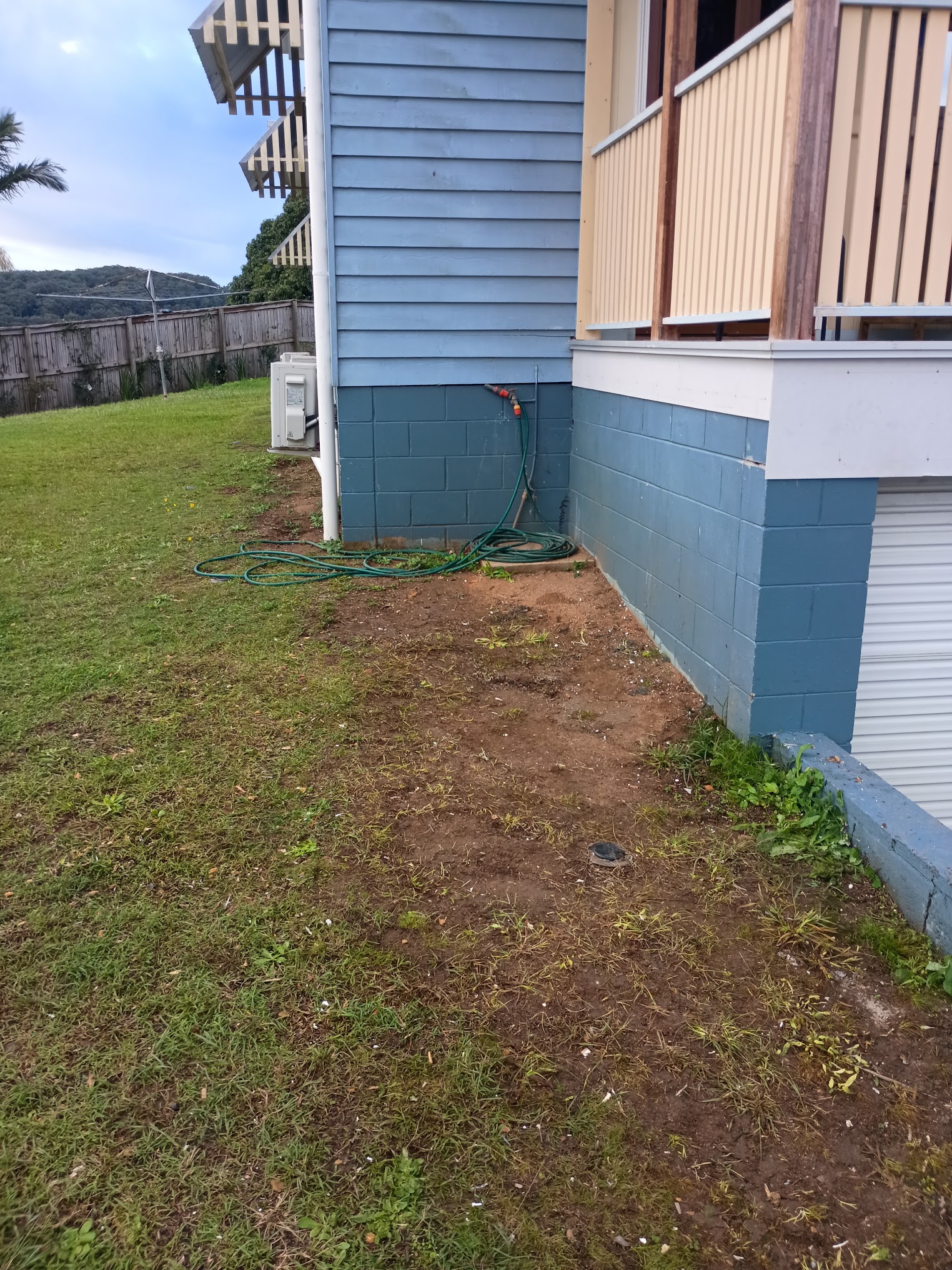 Cleared site along the side of a house after rubbish removal