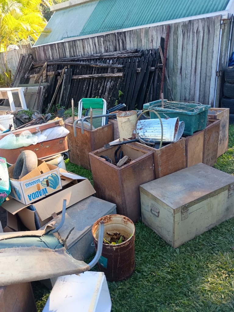 Backyard clean-out with crates, boxes and household items ready for removal