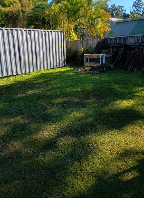 Site clearance beside a shipping container with fence materials removed