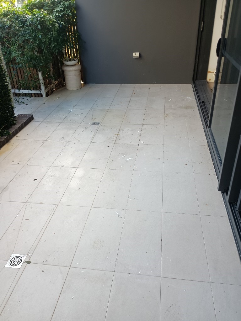 Cleared balcony tiles after carpet removal and site clean up