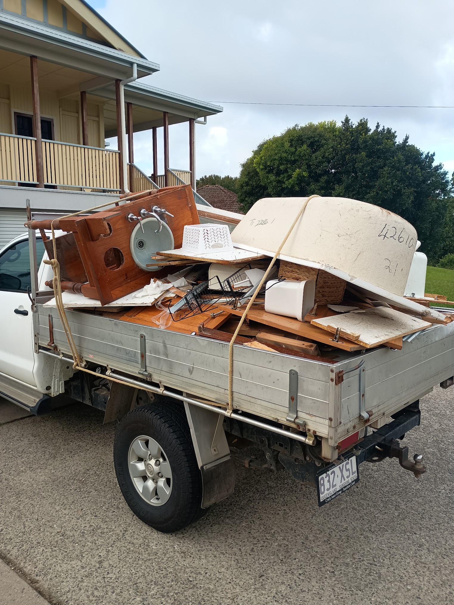 WayMaker ute loaded with bathroom renovation debris including vanity and bathtub