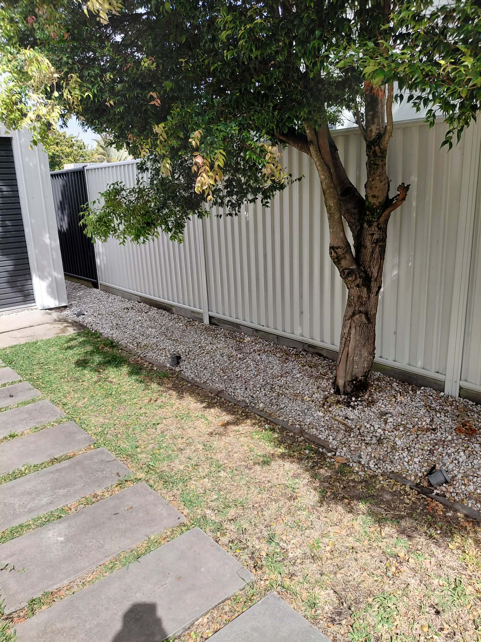 Cleared garden path and gravel border after rubbish removal